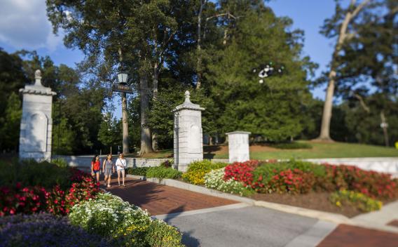 Students walking through Emory's front gate.