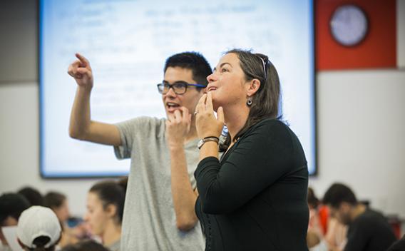 Instructor and student looking up at a projection screen.