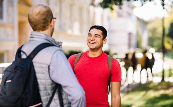 Two men conversing on the Emory quad.